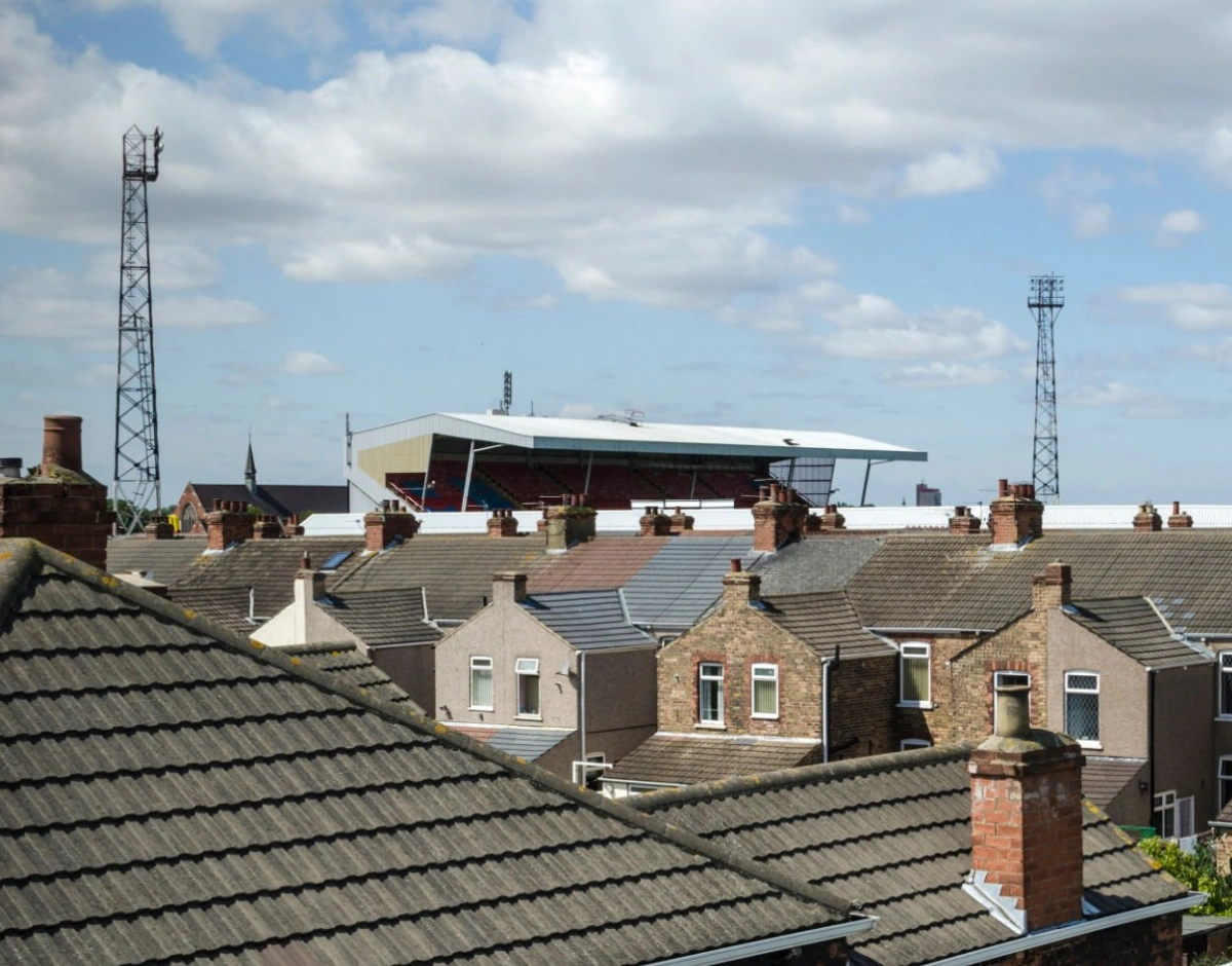 Terraced rooftops of Grimsby with a football stadium beyond