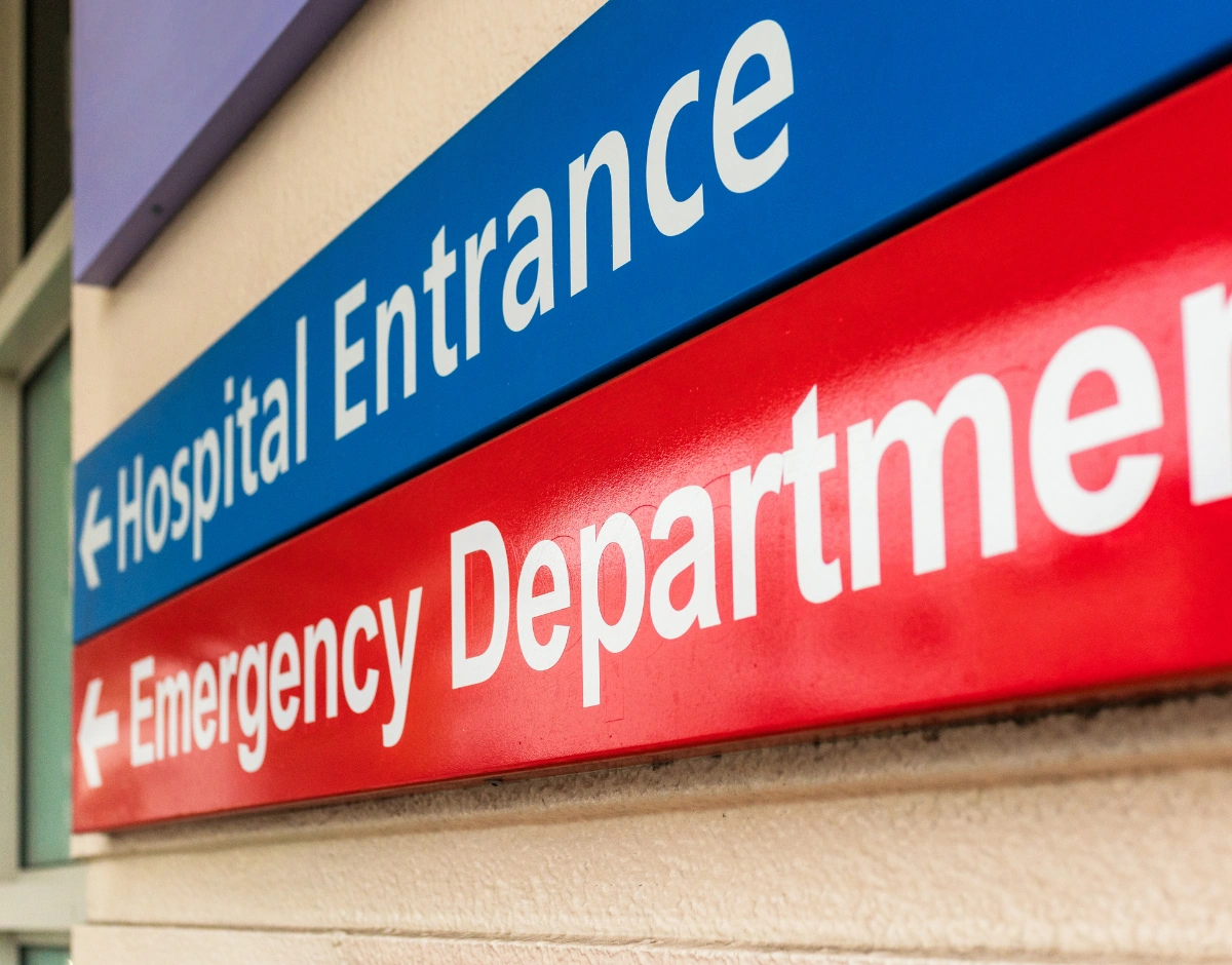 Hospital entrance and emergency department signage, representing IT support for healthcare and the NHS