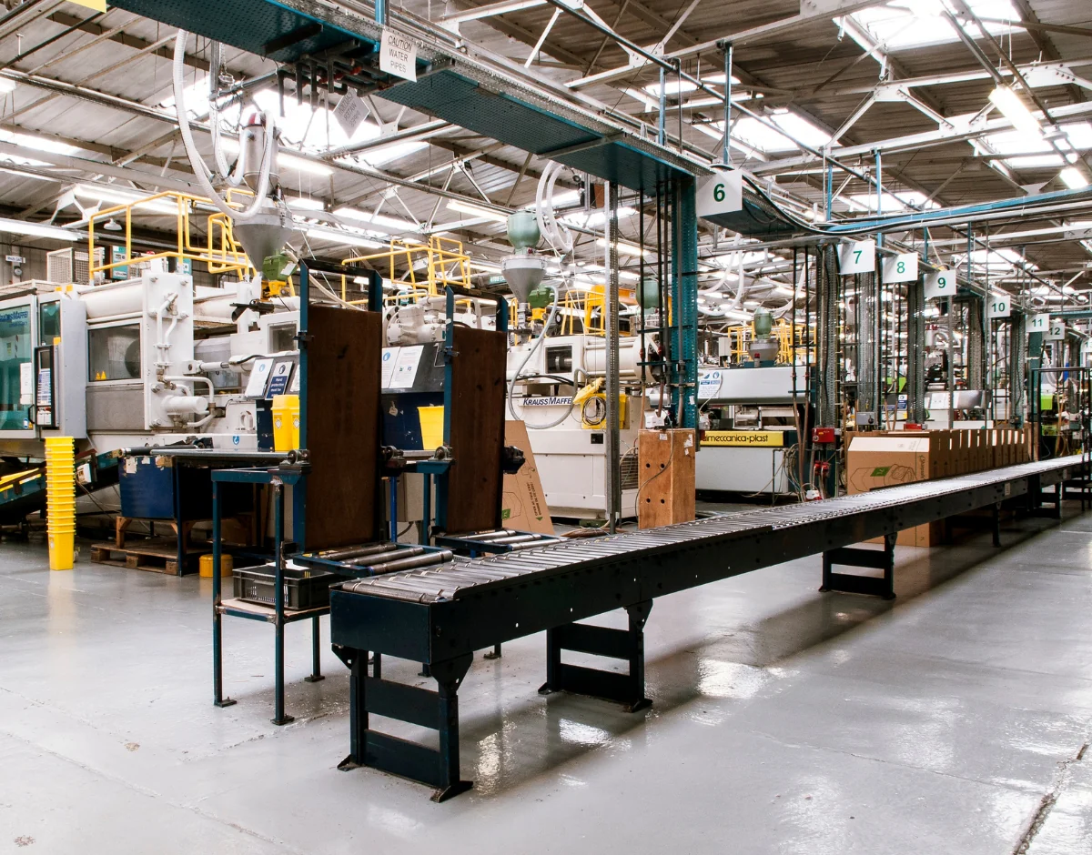 Factory production line with manufacturing machinery, representing IT support for manufacturing and engineering