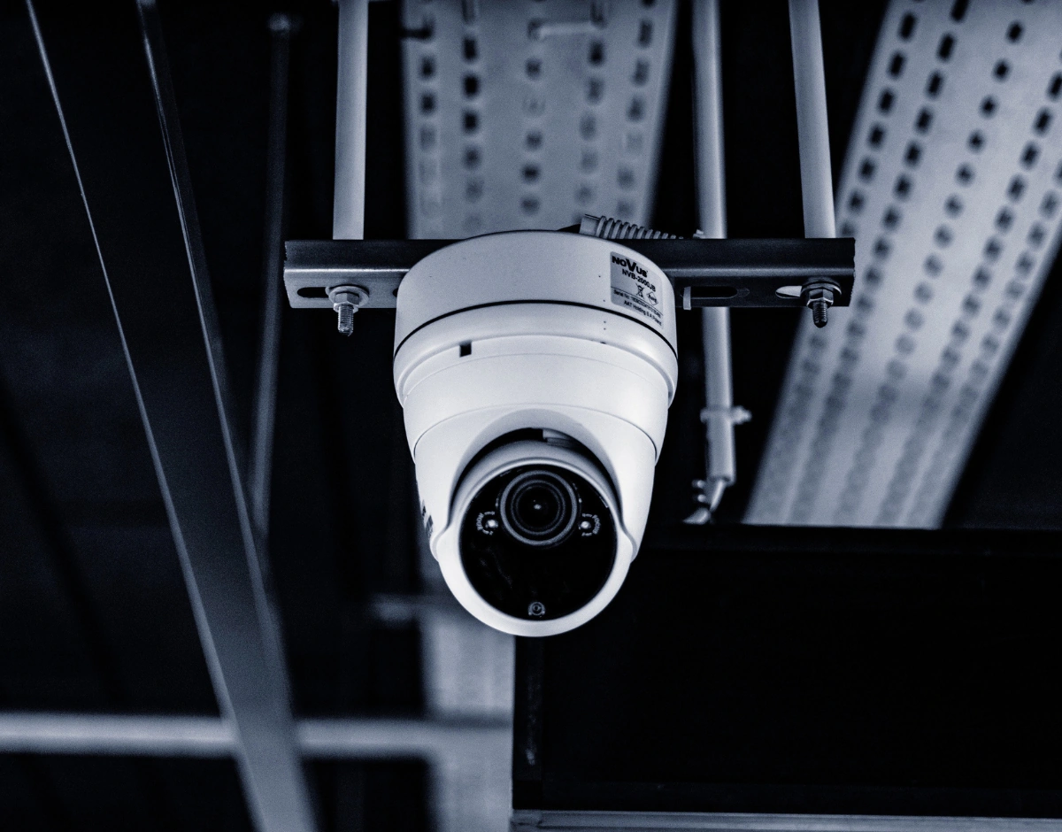 Dome CCTV security camera mounted on a ceiling, representing physical security and surveillance