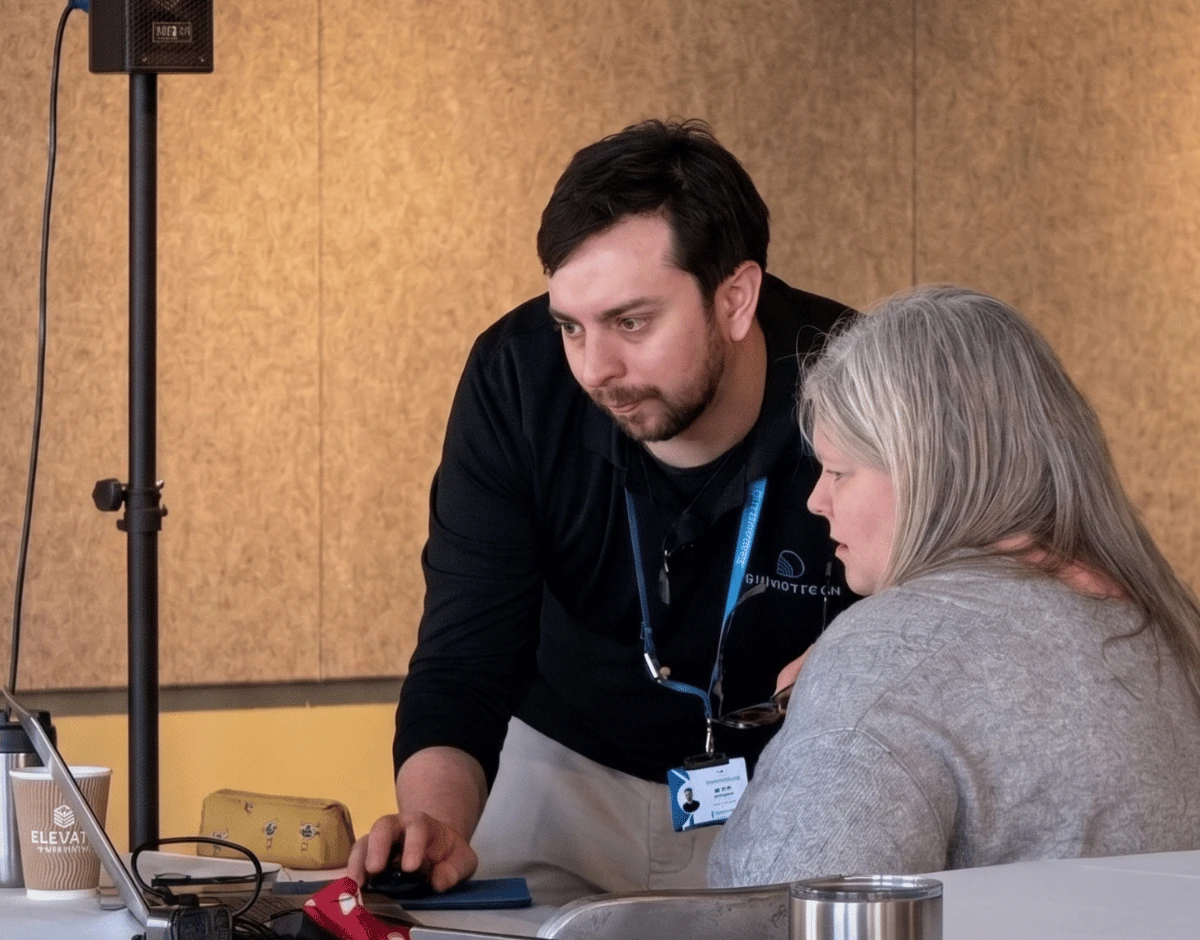PrimaryTech team member providing IT support to a client at an event