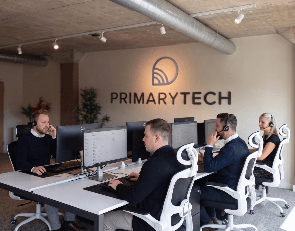 PrimaryTech support team monitoring systems at their desks with headsets