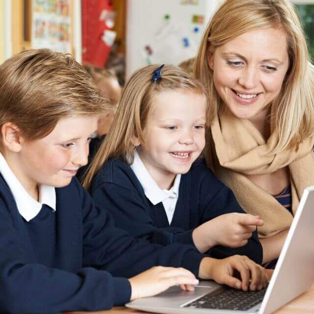 primary school children using laptops